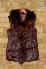 Brown semi-fitted rabbit fur gilet with raccoon trim and pockets