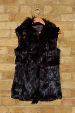 Black semi-fitted rabbit fur gilet with raccoon trim and pockets
